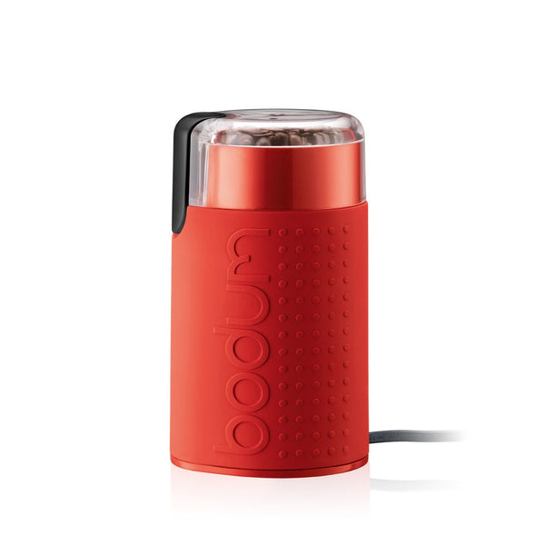 Red coffee grinder with Bodum branding on a white background