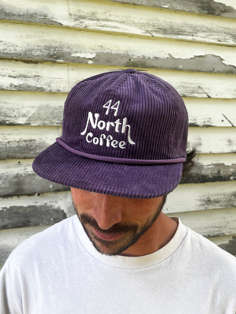 Purple Corduroy 5-Panel Hat with off white nautical 44 North Coffee logo 