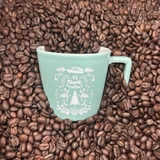 Seafoam mug with white interior with natuical 44 North Coffee logo